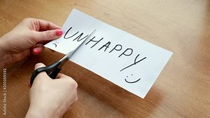 The word writen on the paper unhappy made as happy