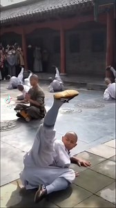 Shaolin Aerial Power: Spinning Strikes & Vertical Flight 🌀🦶 At the Shaolin Temple, monks unleash a stunning display of raw Kung Fu energy. They spin from their backs to their feet, chaining together powerful kicks and explosive punches. One monk soars vertically into the air like a human arrow—then drops, flips, and launches into a blazing flurry of strikes. The crowd watches in awe as centuries of tradition come alive in every movement. #ShaolinTemple #KungFuPower 🥋🔥 | Wing Chun News