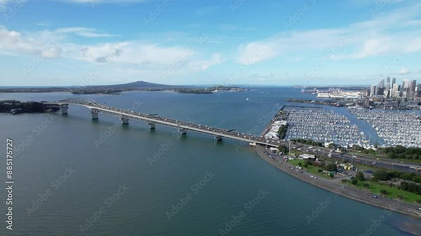 Auckland Harbour Bridge Crossing Waitemata Harbour In Auckland, New Zealand. aerial panning shot
