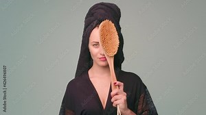 Dry body brush, Woman dry brushing body to reduce cellulite, detoxify the lymphatic system, and achieve beautiful smooth skin. Dry skin brushing as part of morning health and energy routine.