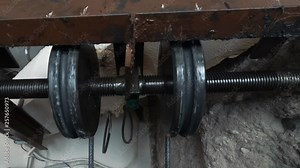 lift machinist repairing elevator in lift shaft. lift mechanism close-up