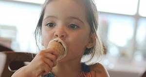clip-1038532667-little-girl-eating-ice-cream-cone