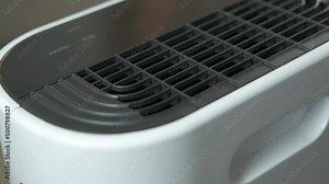 New portable air conditioner unit. Somebody switch on the new small air conditioner to clean the home air.