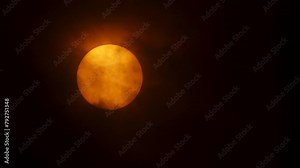 Very heavy clouds in front of the sun, close up, sun spots visible