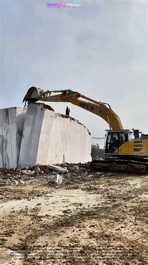 Demolition in Motion: Excavator Takes Down Concrete Wall: Efficient Deconstruction for Redevelopment