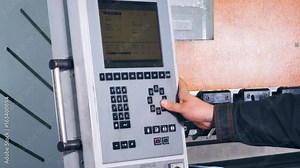 Worker controling and operating manufacturing process on a control panel.