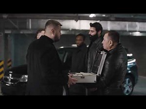 VideoVault Stock Video: Criminals from the mafia with gun hand over suitcase full of money