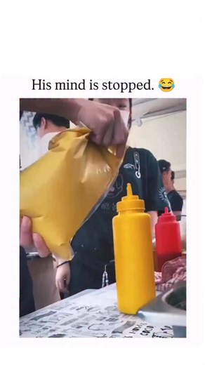 Brainbites.io on Instagram: "The Instagram reel features a 26-second video clip from a food preparation setting, showing two young employees awkwardly pouring mustard from a large bottle into a yellow pouch using makeshift methods, culminating in their manager’s visibly stunned expression of disbelief. , an account specialising in reposting positive viral content and IQ tests, the clip has garnered over 2,100 likes and 227,000 views since October 2025, with replies focusing on humorous takes lik
