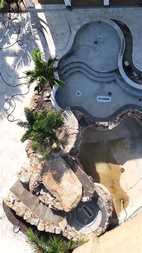 This backyard paradise has it all: a massive grotto, elevated spa, upper and lower pools