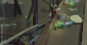 Waste sorting center. recycling of plastic packaging. plastic bottles move along a conveyor belt for sorting and processing. Close-up.