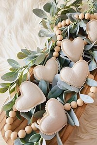 Rustic hearts using scrap neutral fabric and a pair of pinking shears to get those beautiful scalloped edges. After lightly stuffing them, I hand-stitched around the border to keep that raw, cozy feel. #diy #ValentinesDay | DIY Crafts and Projects