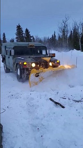 Snow plowing humvee