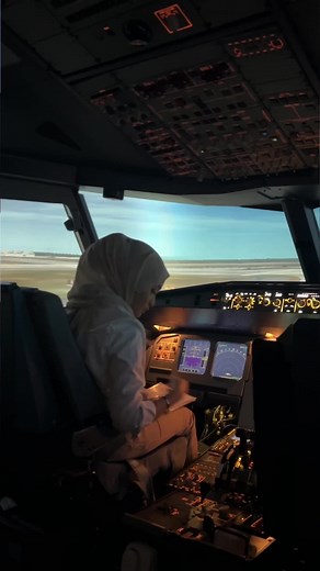 Female Pilot Operating Modern Cockpit Controls