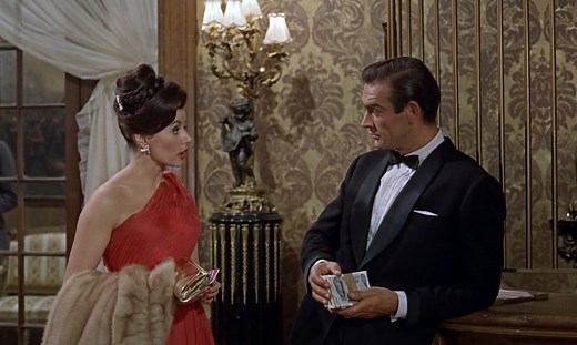 Bond costume designer Lindy Hemming selects her standout moment of style in 60 years of Bond. “My favourite moment has to be Sean Connery arriving in his first casino scene in DR.NO. His midnight blue tuxedo with turned back satin cuffs and satin covered buttons are the first thing we see. It's the beginning of an iconic journey both for Bond and his tuxedo.” | James Bond 007