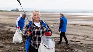 Lottery winners worth £100million volunteer to clean up Scots beach