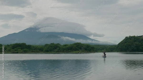 Monte Fuji with lenticular cloud and fisherman in boat on Lake Shoji. Footage with correct color profile and basic color grading for versatile use. 24P, F-Log2, MOVH.265, All-I 422, 10bit, 360Mbps.
