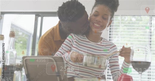 Woman stirring saucepan, man leaning in starting hug, bonding while tech overlay guiding meal prep