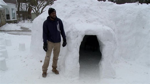 Man builds yard igloo with multiple rooms.