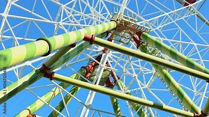 Exploring the vibrant structure of a giant ferris wheel on a sunny day at the amusement park