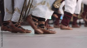 Traditional romanian folklore dancers in traditional costumes dancing on stage in slow motion