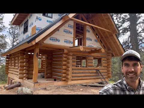 Staining complete, Chinking started, and a massive truck made the top of the hill! Log Cabin Build