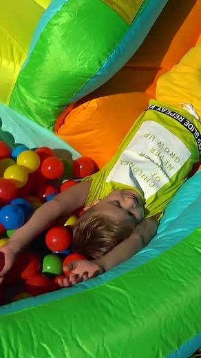 Child's Joyful Playtime in Colorful Inflatable Structure