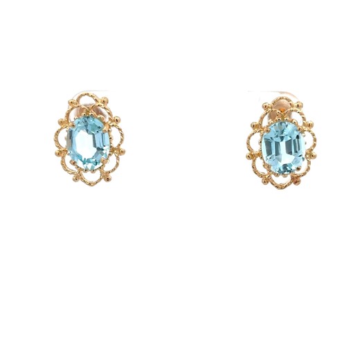 Indulge in elegance with our 14k yellow gold blue topaz earrings, each boasting a captivating oval blue topaz embraced by an intricate open-worked frame of gold with a scalloped design. Adorned with pierced friction back posts, this set exudes sophistication and style. Blue topaz is celebrated for its soothing properties, making these earrings not just a fashion statement, but also a source of tranquility. Priced at $350, seize the opportunity to own this exquisite pair, as only one set is avail