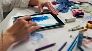 Design studio for creative people who create clothes. The process of creating a sketch model on an electronic tablet. Create dress clothes on tablet online. Fashion designer