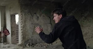 Two athletes train freestyle wrestling techniques in abandoned building