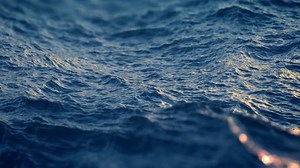 Slow motion close up of disturbed blue ocean water surface. Nice looping background (4K,ultra high definition 2160p, seamless loop), slow motion