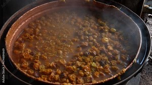 Production of plum brandy in the traditional way. Hot fermented plums in a cauldron for distilling brandy, Cauldron for roasting brandy, part of an old cauldron for roasting plum brandy