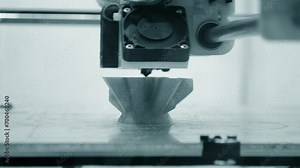 Working 3D printer printing an object from plastic. Printing a model from molten plastic using a 3D printer. Creation of a form by a 3D printer. Additive progressive new modern 3d printer technology