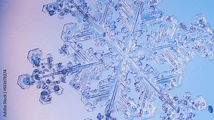 Snowflake close up under microscope panning view blue background fine details