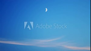 Waxing crescent moon in sky. Moon moves across the sky. Time lapse.