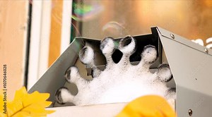 Soap bubble generator produces soap bubbles on open air outdoor. Automatic soap bubble blowing machine, slow-motion. Stock Video