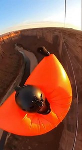 Giant Orange Inflatable Suit Wobbles Across Canyon Zipline at Sunset 😂