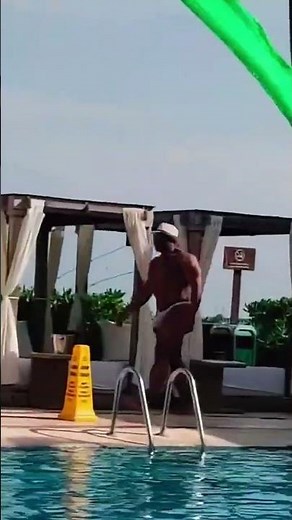 Bodybuilder poolside in Muscle Potential Swimwear