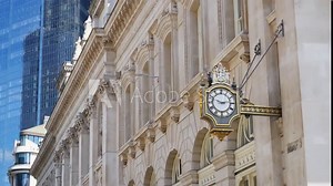 Clock on the side of the Royal Stock Exchange building in London.
