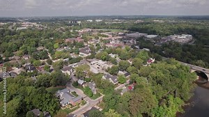 Aerial landscape and drone shot of downtown Dublin, Ohio, a rich suburb and town northwest of Columbus, OH with plenty of trees, businesses, restaurants, and houses during a warm summer day