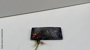 Broken phone. Hammer hitting the display breaks the mobile phone. Mobile smartphone with a broken screen. Drop Test. Hammer Durability. Hammer vs mobile display. Smashing the Phone. Breaking display.