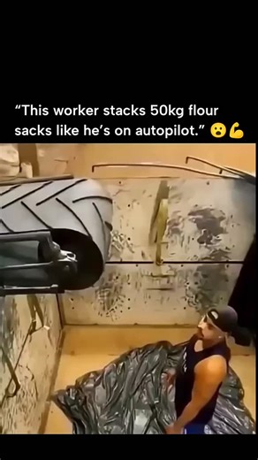 Curvico Explained on Instagram: "The post features a viral video from late 2025 showing a muscular warehouse worker stacking 50kg flour sacks onto a pallet conveyor at machine-like speeds, lifting and positioning them with effortless precision over nearly a minute. Posted by Turkish account @bezgin4 , known for entertainment and sports content, the caption "Abi otomatiğe bağlamış kendini" translates to "Bro, he's put himself on autopilot," highlighting the humorous awe at his rhythmic efficiency