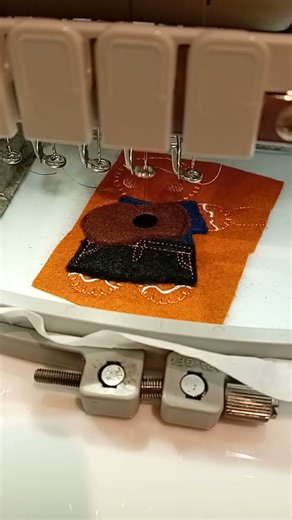 Guitar playing musician keyring on a PR1000E embroidery machine. Making stock.