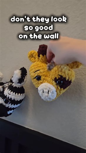 Safari heart crochet decor 🦓🦒 I love plushies, but I also wanted a way to turn crochet into something that feels like home decor. The zebra and giraffe safari hearts look so cute styled together and add a little handmade touch to the space. Sometimes crochet doesn’t have to sit on a shelf — it can be part of the room. Would you hang these in a nursery, craft room, or living space? #crochettok #homedecor #crochettiktok #crochetpattern #crochetplushie