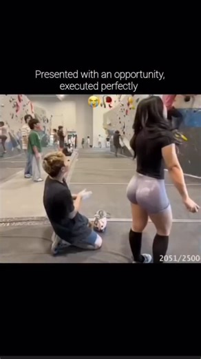 🙂 on Instagram: "This video depicts a staged comedic interaction inside an indoor rock climbing gym, featuring a man and a woman standing on the bouldering mats. The scene begins with the man kneeling and pointing out that the woman has white climbing chalk on the back of her light purple shorts. After a brief exchange where he claims to have brushed it off, the woman questions him, asking if he is sure he removed all of it. She then squats down to inspect, revealing that the chalk mark is stil