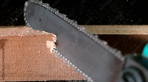 Super slow motion of detail of a chainsaw cutting the wood. Filmed on very high speed cinema camera, 1000 fps.