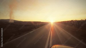 Countryside Road Trip During Scenic Sunset. Car Driving on the rural sunset road