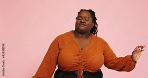 African-American plus size model dances looking into camera