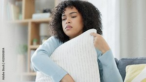 Sad woman crying after reading a breakup text message on her phone. Young female, upset after receiving bad news, brought her to tears. Suffering from loss or having an emotional breakdown