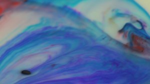 Mix of multi-colored paints flowing slowly - Free Stock Video