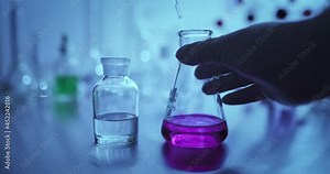 Hand scientist shaking Erlenmeyer flask with chemical liquid, Scientific equipment and science technology concept Stock Video